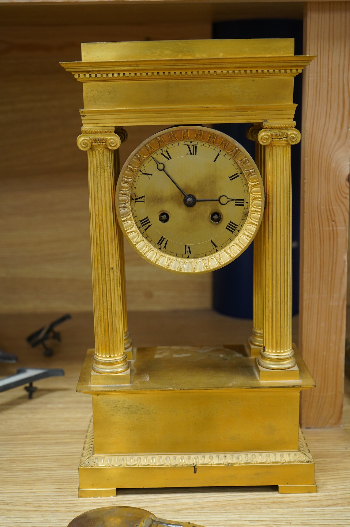 A 19th century French gilt brass eight day portico clock with pendulum, 38cm